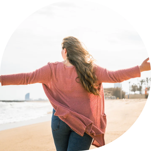 Woman open arms in front of the beach